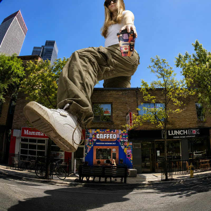 A customer mid-jump outside the Caffeo storefront on Richmond Street West